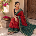 Red and green Kutch tie-dye Bandhani cotton saree, draped and worn by a woman, by artisan Shabana Khatri, AI visual of the saree, iTokri