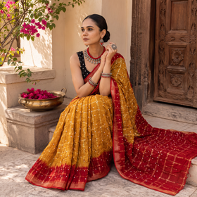 Mustard yellow and red Kutch tie-dye Bandhani cotton saree, draped and worn by a woman, by artisan Shabana Khatri, AI visual of the saree, iTokri