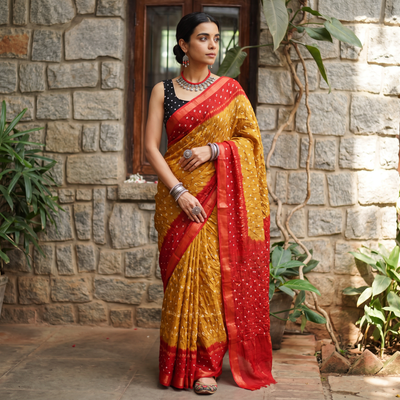Mustard yellow and red Kutch tie-dye Bandhani cotton saree, draped and worn by a woman, by artisan Shabana Khatri, AI visual of the saree, iTokri
