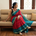 Red and teal Kutch tie-dye Bandhani cotton saree, draped and worn by a woman, by artisan Shabana Khatri, AI visual of the saree, iTokri