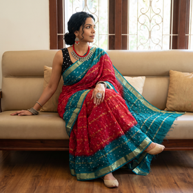 Red and teal Kutch tie-dye Bandhani cotton saree, draped and worn by a woman, by artisan Shabana Khatri, AI visual of the saree, iTokri