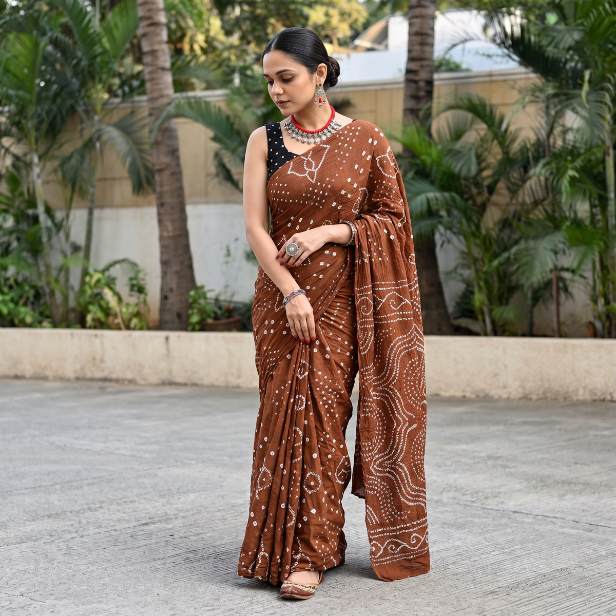 Brown Kutch tie-dye pure cotton Bandhani saree, draped and worn by a woman, AI visual of the saree, iTokri