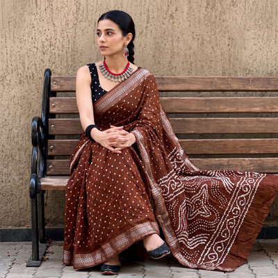 Brown Kutch tie-dye pure cotton Bandhani saree with border, draped and worn by a woman, AI visual of the saree, iTokri