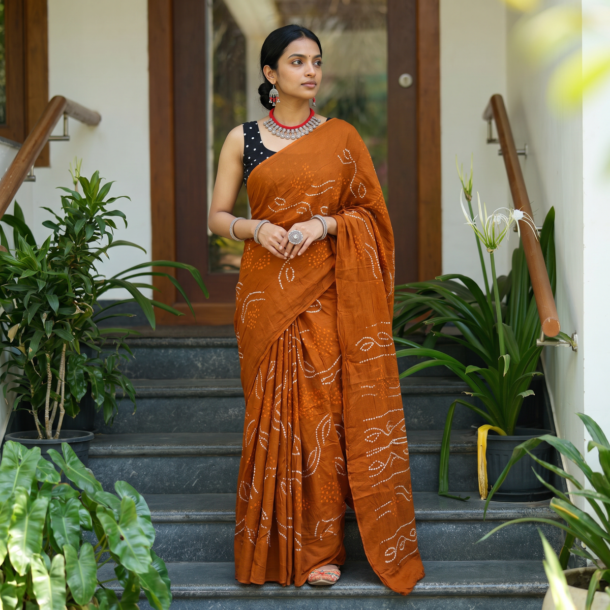 Orange Kutch tie-dye pure mul cotton rai Bandhani saree, draped and worn by a woman, AI visual of the saree, iTokri