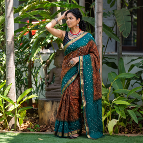 Brown and teal Kutch tie-dye Shibori Bandhani cotton saree, draped and worn by a woman, by artisan Shabana Khatri, AI visual of the saree, iTokri
