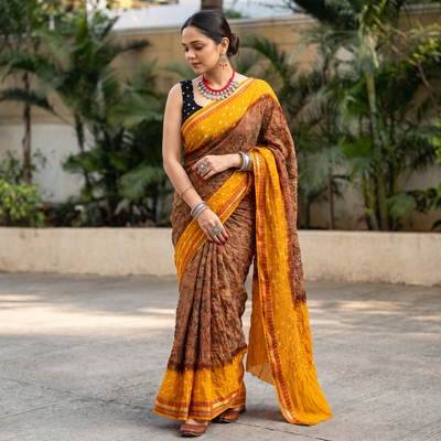 Brown and mustard yellow Kutch tie-dye Shibori Bandhani cotton saree, draped and worn by a woman, by artisan Shabana Khatri, AI visual of the saree, iTokri
