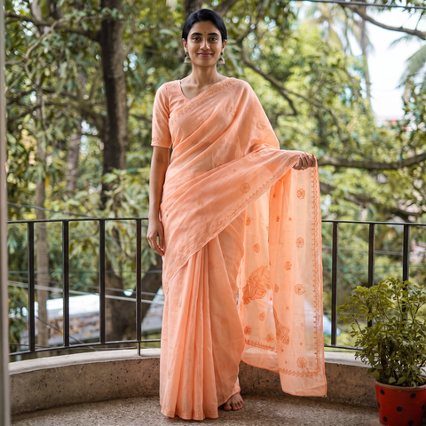 Peach Lucknow Chikankari Hand Embroidery Terivoile Cotton Saree, draped and worn by a woman, AI visual of the saree, iTokri