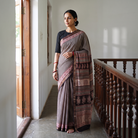 Black Maheshwari Silk Natural Dyed Bagh Hand Block Print Saree with Zari Border, draped and worn by a woman, AI visual of the saree, iTokri