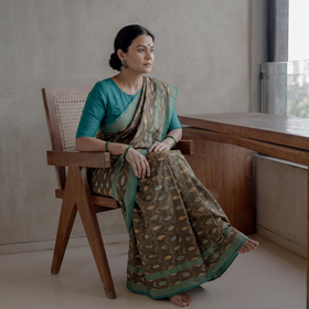 Green Mercerised Cotton Handloom Pochampally Ikat Saree, draped and worn by a woman, AI visual of the saree, iTokri