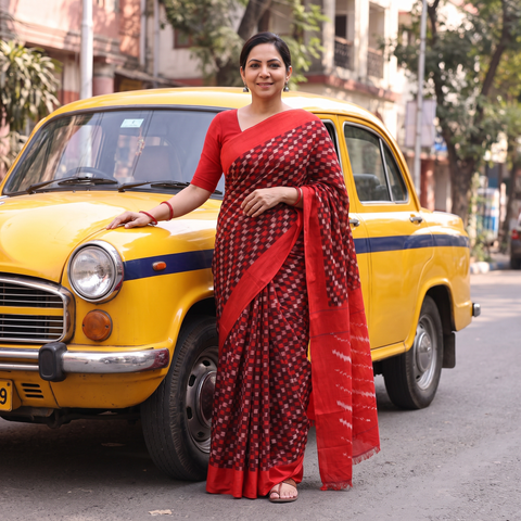 Red Mercerised Cotton Handloom Pochampally Ikat Saree, draped and worn by a woman, AI visual of the saree, iTokri