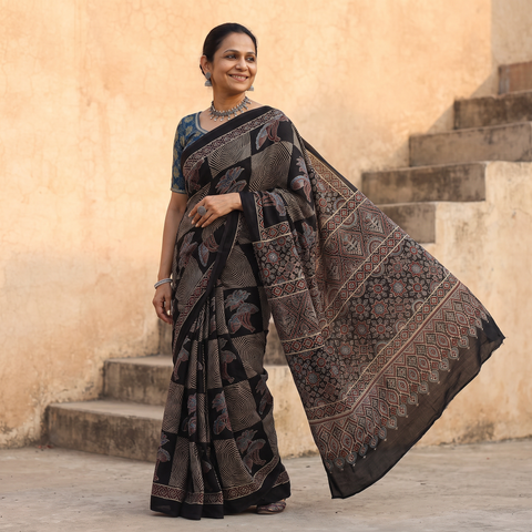 Black Modal Silk Block Print Ajrakh Saree, draped and worn by a woman, AI visual of the saree, iTokri