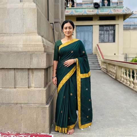 Green Mul Cotton Ajrakh Patchwork Saree with Tagai Mirror Work, draped and worn by a woman, AI visual of the saree, iTokri