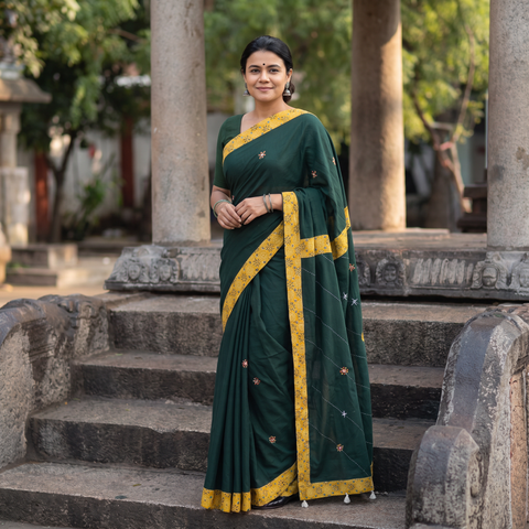Green Mul Cotton Ajrakh Patchwork Saree with Tagai Mirror Work, draped and worn by a woman, AI visual of the saree, iTokri
