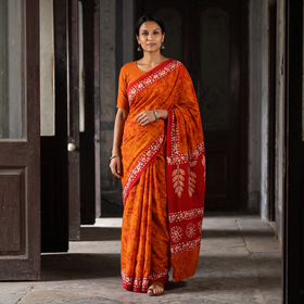 Orange Mul Cotton Hand Batik Print Saree, draped and worn by a woman, AI visual of the saree, iTokri