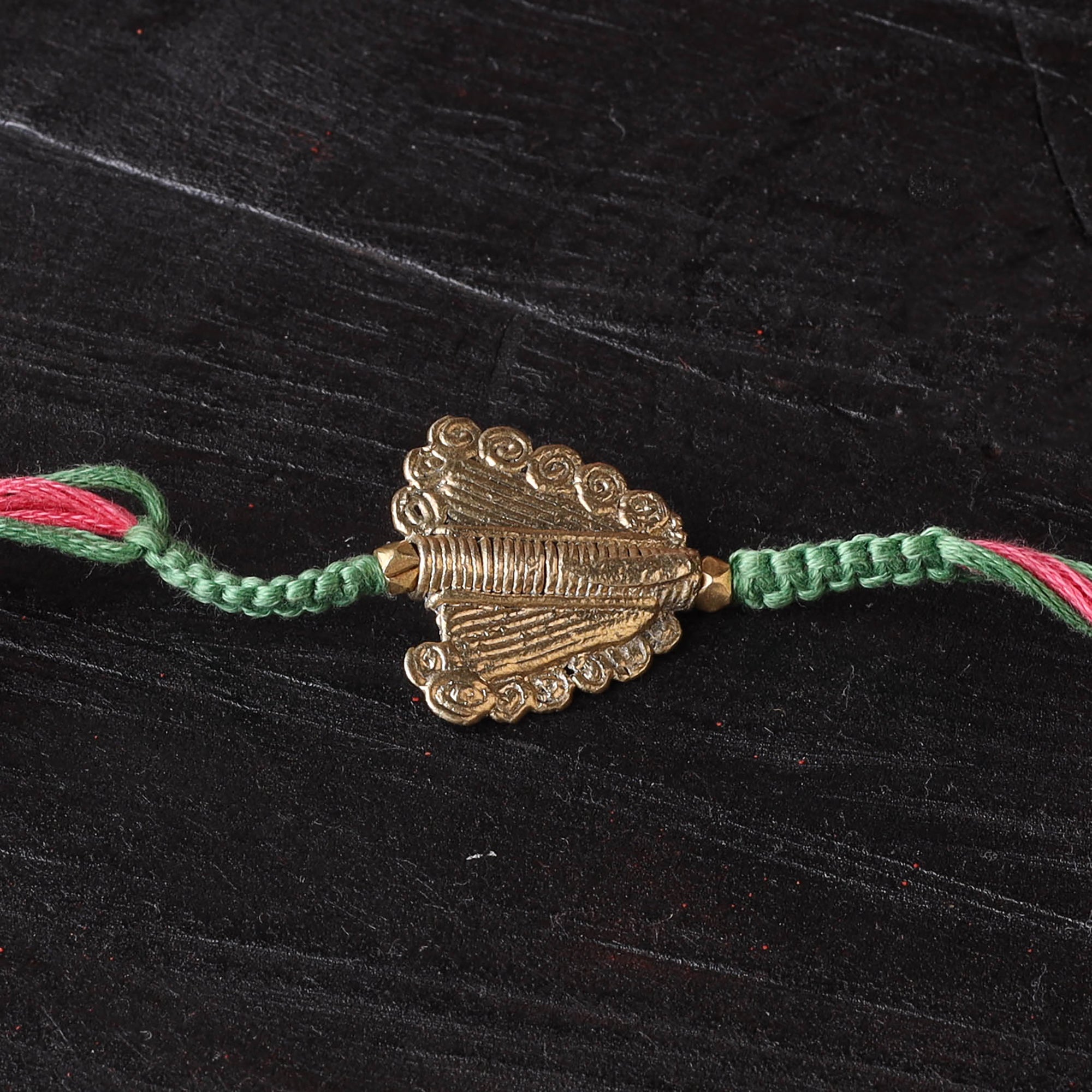 Handcrafted tribal dokra brass thread rakhi 01