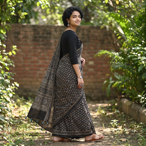 Black Natural Dyed Block Print Mul Cotton Ajrakh Saree, draped and worn by a woman, AI visual of the saree, iTokri