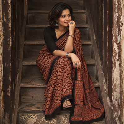 Brown Ajrakh hand block print natural dyed cotton saree, draped and worn by a woman, AI visual of the saree, iTokri