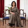 Grey Ajrakh hand block print natural dyed cotton saree, draped and worn by a woman, AI visual of the saree, iTokri