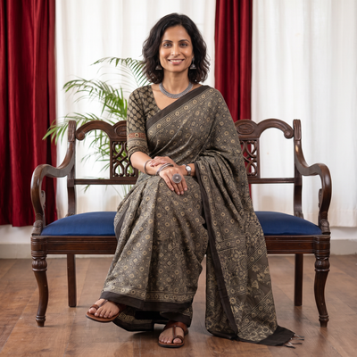Grey Ajrakh hand block print natural dyed cotton saree, draped and worn by a woman, AI visual of the saree, iTokri