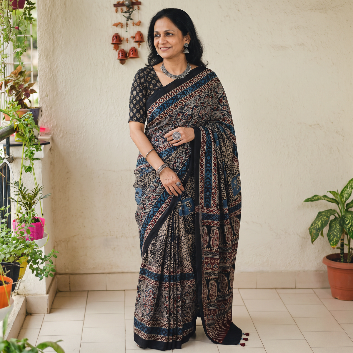 Black Natural Dyed Modal Silk Kutch Hand Block Print Ajrakh Saree, draped and worn by a woman, AI visual of the saree, iTokri