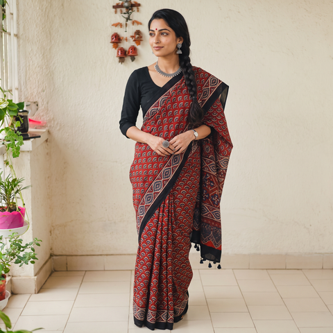 Red Natural Dyed Modal Silk Kutch Hand Block Print Ajrakh Saree, draped and worn by a woman, AI visual of the saree, iTokri