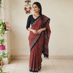 Red Natural Dyed Modal Silk Kutch Hand Block Print Ajrakh Saree, draped and worn by a woman, AI visual of the saree, iTokri