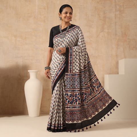 White Natural Dyed Modal Silk Kutch Hand Block Print Ajrakh Saree, draped and worn by a woman, AI visual of the saree, iTokri