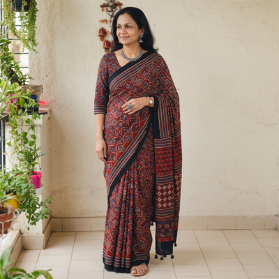Red Natural Dyed Modal Silk Kutch Hand Block Print Ajrakh Saree, draped and worn by a woman, AI visual of the saree, iTokri