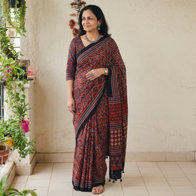 Red Natural Dyed Modal Silk Kutch Hand Block Print Ajrakh Saree, draped and worn by a woman, AI visual of the saree, iTokri