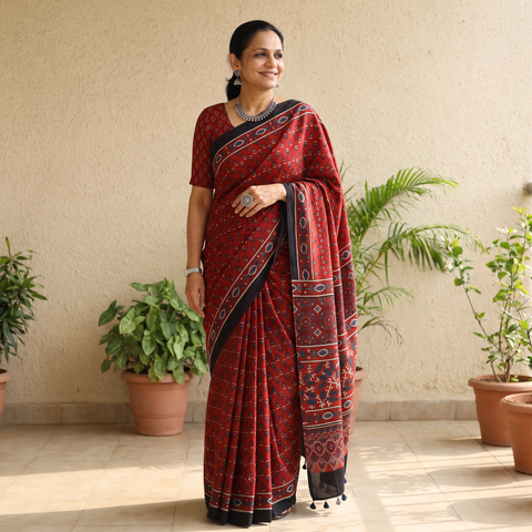 Red Natural Dyed Modal Silk Kutch Hand Block Print Ajrakh Saree, draped and worn by a woman, AI visual of the saree, iTokri