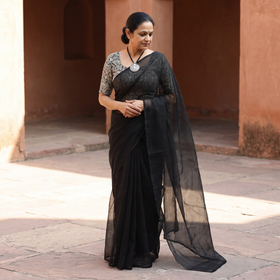 Black Nazaakat Kota Doria Cotton Plain Saree with Blouse & Jewellery Set, draped and worn by a woman, AI visual of the saree, iTokri
