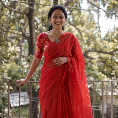 Red Nazaakat Kota Doria Cotton Plain Saree with Blouse & Jewellery Set, draped and worn by a woman, AI visual of the saree, iTokri