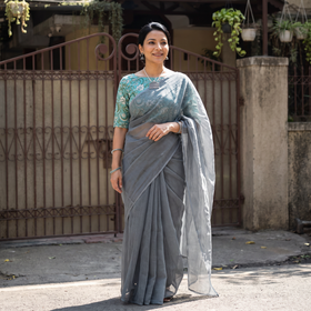 Grey Nazaakat Kota Doria Cotton Plain Saree with Blouse & Jewellery Set, draped and worn by a woman, AI visual of the saree, iTokri