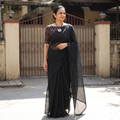 Black Nazaakat Kota Doria Cotton Plain Saree with Blouse & Jewellery Set, draped and worn by a woman, AI visual of the saree, iTokri