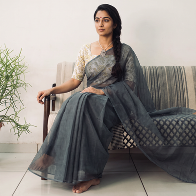 Grey Nazaakat Kota Doria Cotton Plain Saree with Blouse & Jewellery Set, draped and worn by a woman, AI visual of the saree, iTokri
