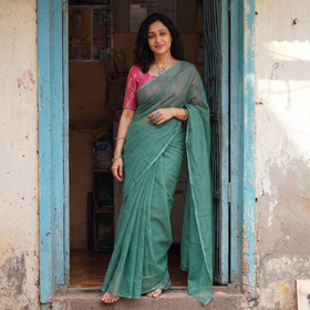 Green Nazaakat Kota Doria Cotton Plain Saree with Blouse & Jewellery Set, draped and worn by a woman, AI visual of the saree, iTokri