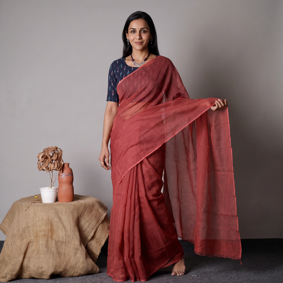 Red Nazaakat Kota Doria Cotton Plain Saree with Blouse & Jewellery Set, draped and worn by a woman, AI visual of the saree, iTokri