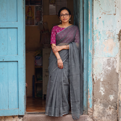Grey Nazaakat Kota Doria Cotton Plain Saree with Blouse & Jewellery Set, draped and worn by a woman, AI visual of the saree, iTokri