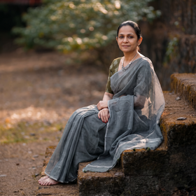 Grey Nazaakat Kota Doria Cotton Plain Saree with Blouse & Jewellery Set, draped and worn by a woman, AI visual of the saree, iTokri