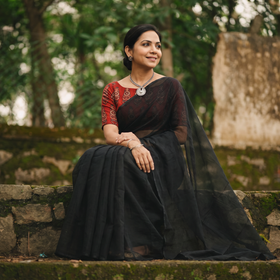 Black Nazaakat Kota Doria Cotton Plain Saree with Blouse & Jewellery Set, draped and worn by a woman, AI visual of the saree, iTokri