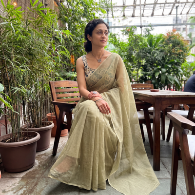Green Nazaakat Kota Doria Cotton Plain Saree with Blouse & Jewellery Set, draped and worn by a woman, AI visual of the saree, iTokri