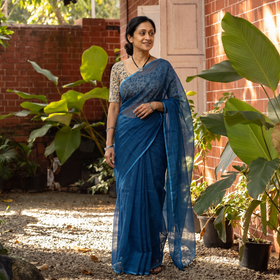 Blue Nazaakat Kota Doria Cotton Plain Saree with Blouse & Jewellery Set, draped and worn by a woman, AI visual of the saree, iTokri