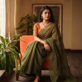 Green Nazaakat Kota Doria Cotton Plain Saree with Blouse & Jewellery Set, draped and worn by a woman, AI visual of the saree, iTokri