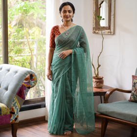 Green Nazaakat Kota Doria Cotton Plain Saree with Blouse & Jewellery Set, draped and worn by a woman, AI visual of the saree, iTokri