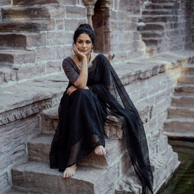 Black Nazaakat Kota Doria Cotton Plain Saree with Blouse & Jewellery Set, draped and worn by a woman, AI visual of the saree, iTokri