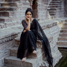 Black Nazaakat Kota Doria Cotton Plain Saree with Blouse & Jewellery Set, draped and worn by a woman, AI visual of the saree, iTokri