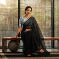 Black Nazaakat Kota Doria Cotton Plain Saree with Blouse & Jewellery Set, draped and worn by a woman, AI visual of the saree, iTokri