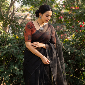 Black Nazaakat Kota Doria Cotton Plain Saree with Blouse & Jewellery Set, draped and worn by a woman, AI visual of the saree, iTokri