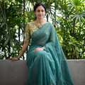 Green Nazaakat Kota Doria Cotton Plain Saree with Blouse & Jewellery Set, draped and worn by a woman, AI visual of the saree, iTokri