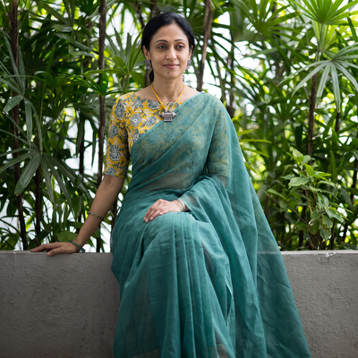 Green Nazaakat Kota Doria Cotton Plain Saree with Blouse & Jewellery Set, draped and worn by a woman, AI visual of the saree, iTokri
